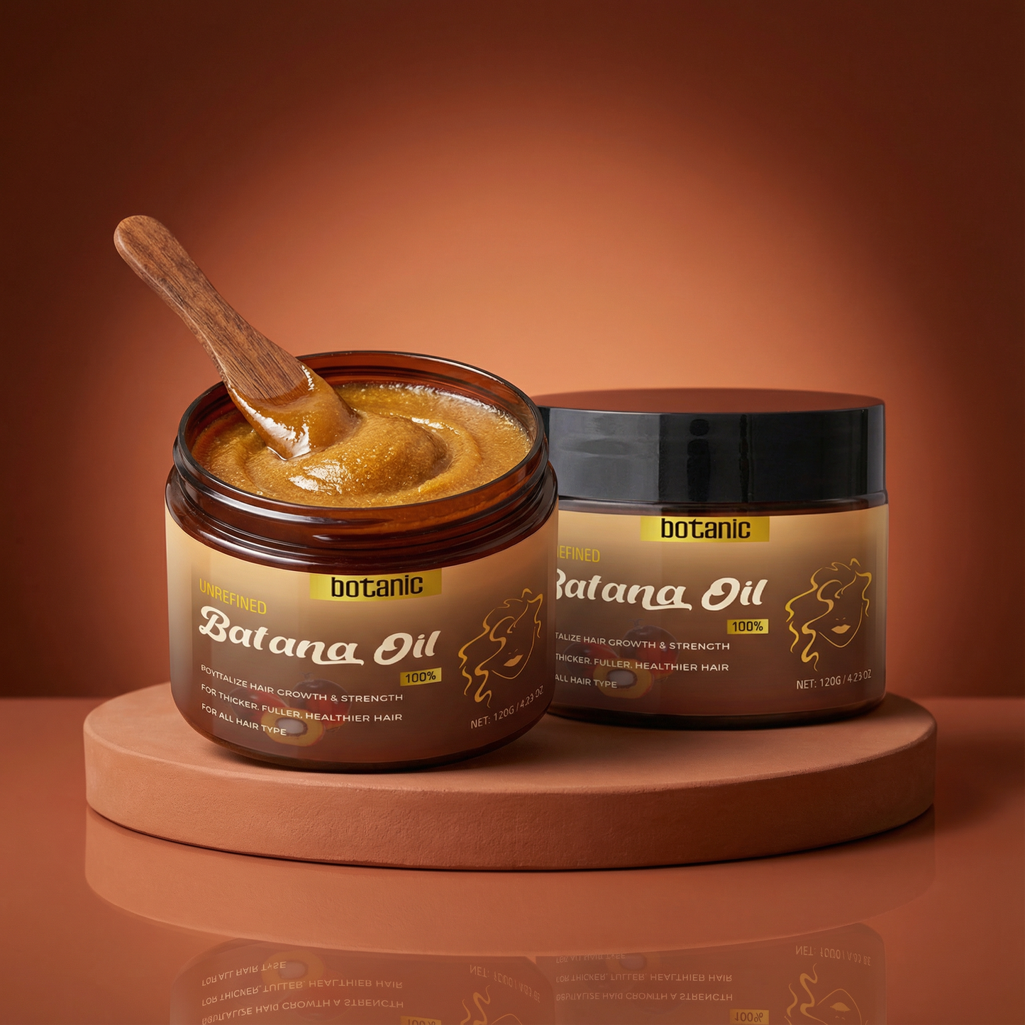 Two jars of botanic Batana Oil with a wooden spoon on a brown background