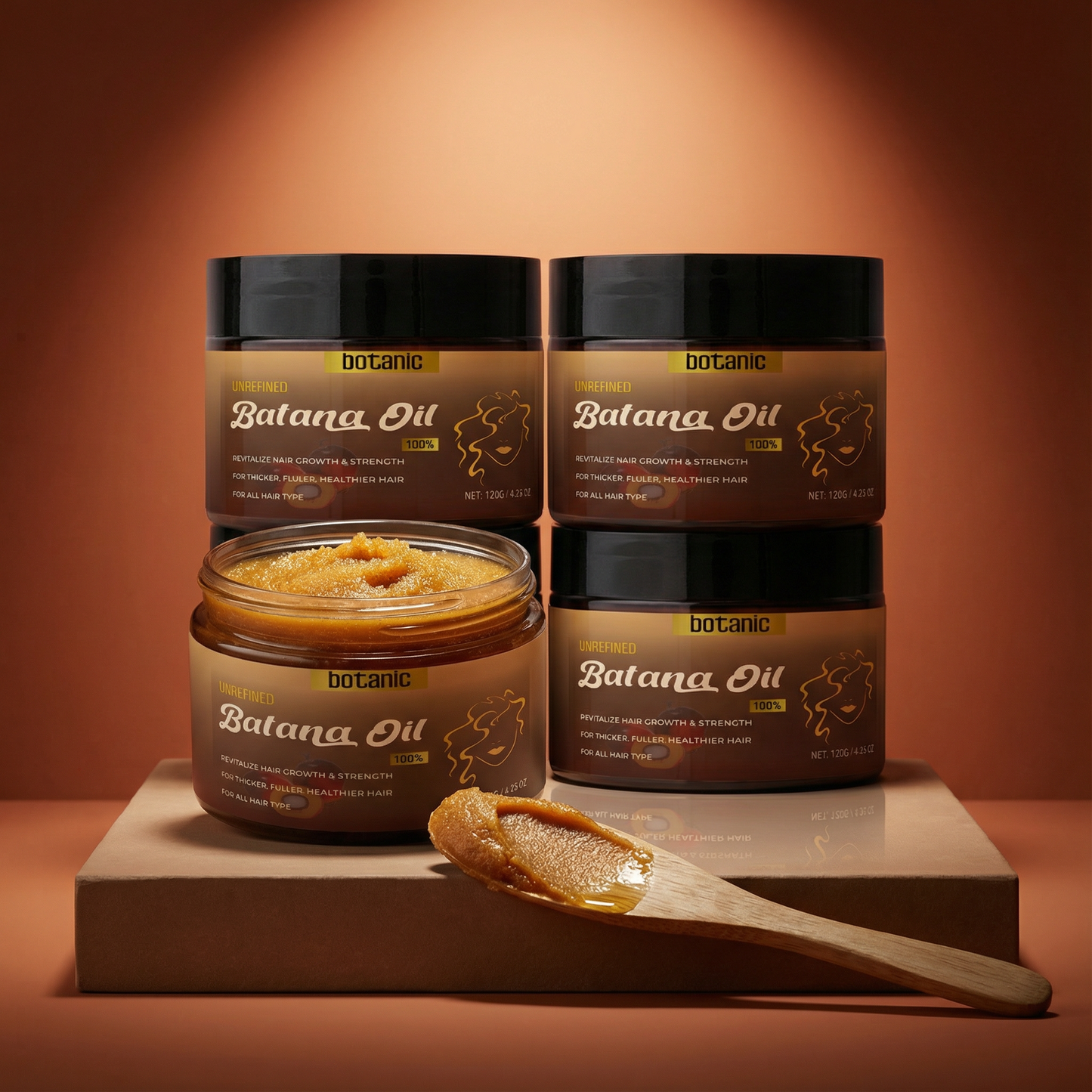 Batana Oil hair care products on a wooden platform with a warm brown background